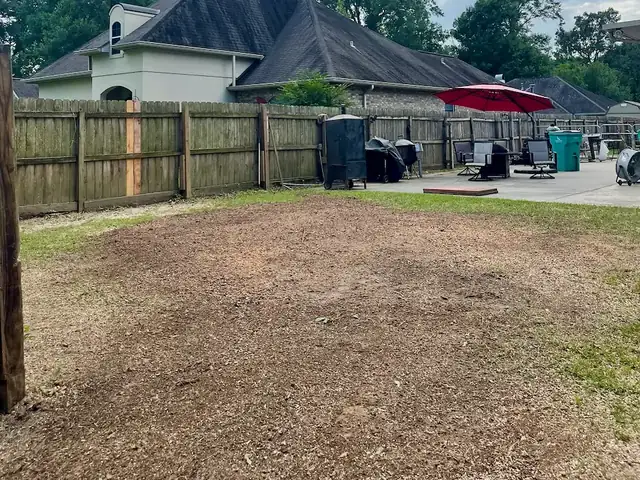 Backyard left level and clean after stump grinding by Apex Tree Care